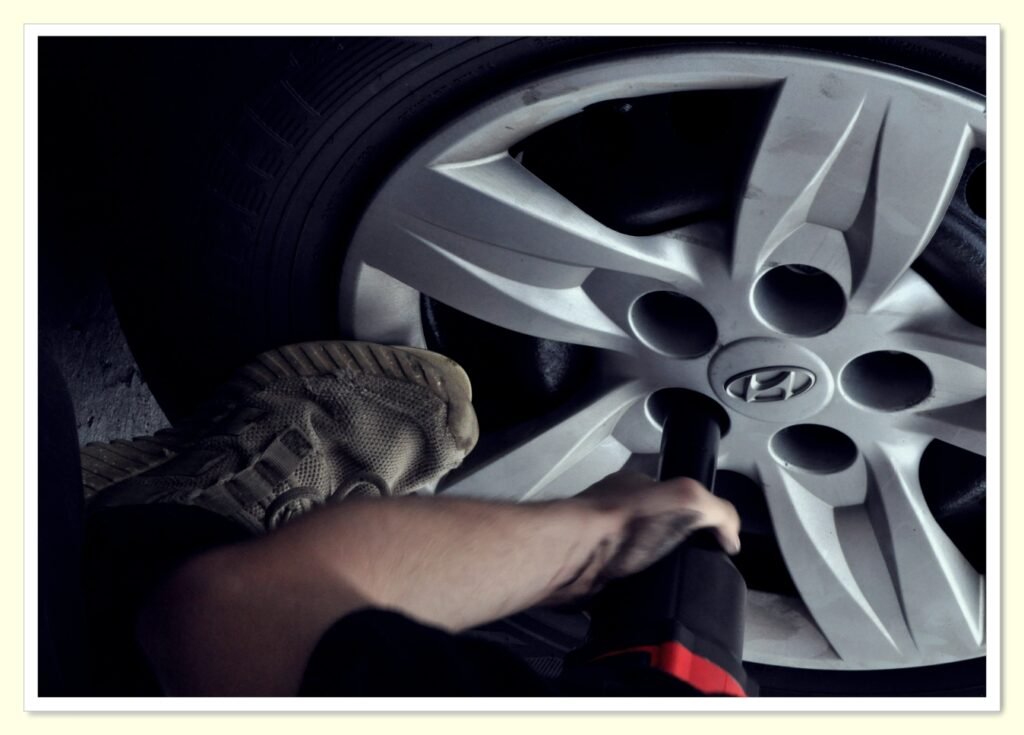 mechanic checking tire pressure for better fuel economy