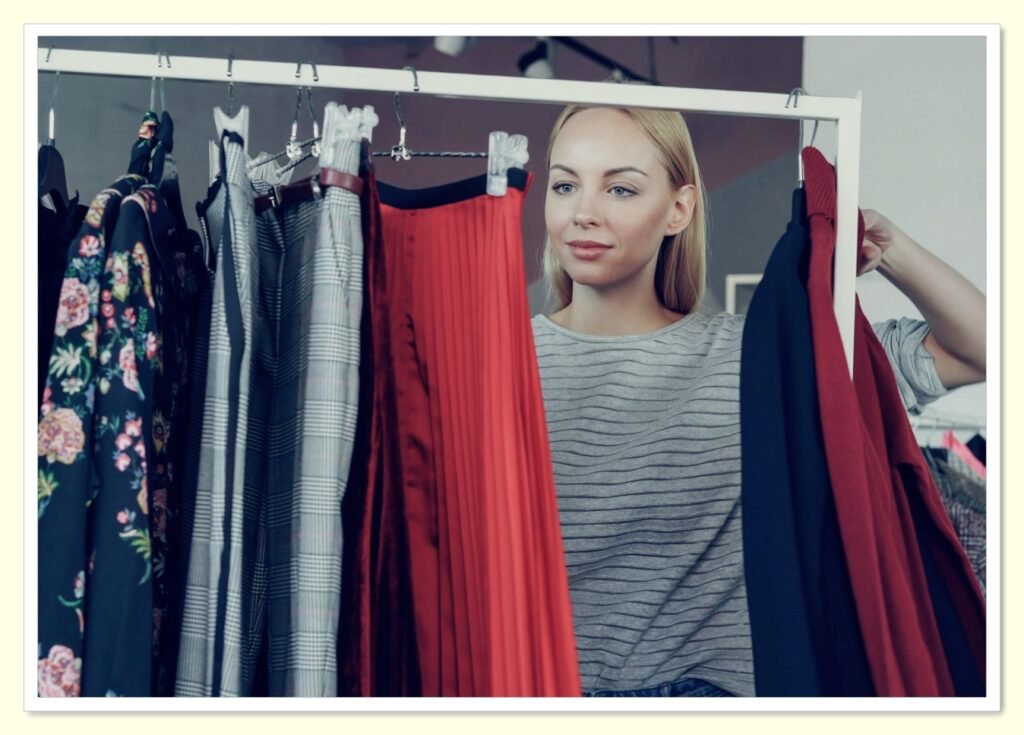 woman browsing clothing sale rack at discount retail store