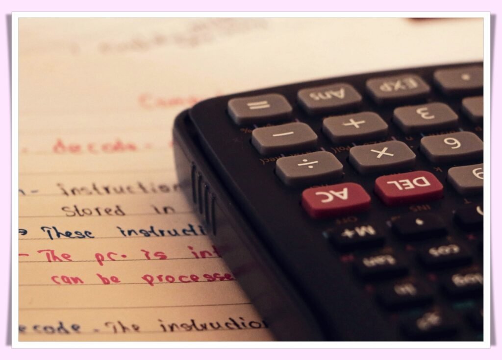 calculator and notebook for debt payoff planning