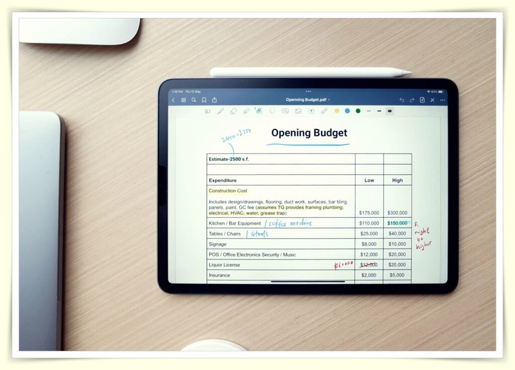person tracking family budget on laptop spreadsheet