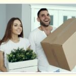 young person moving into first apartment with cardboard boxes