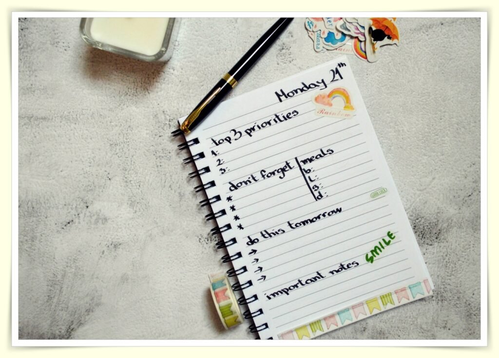 weekly meal plan written in notebook with grocery shopping