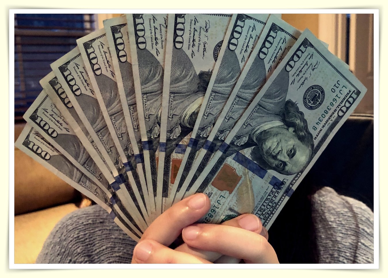 person carefully counting cash on tight minimum wage budget