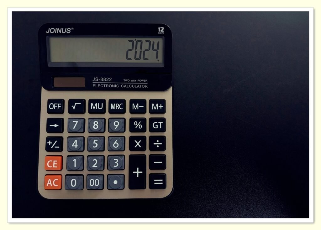 calculator and budget planner showing reduced monthly expenses