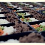 organized meal prep containers in kitchen to reduce food waste