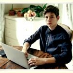 young adult reviewing retirement investment account on laptop