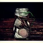 savings jar with cash representing $500 monthly savings goal