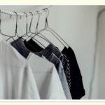 minimal capsule wardrobe hanging in closet to save money on clothes