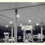 person refueling car at gas station to save money on gas