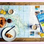 person planning budget vacation with map and suitcase