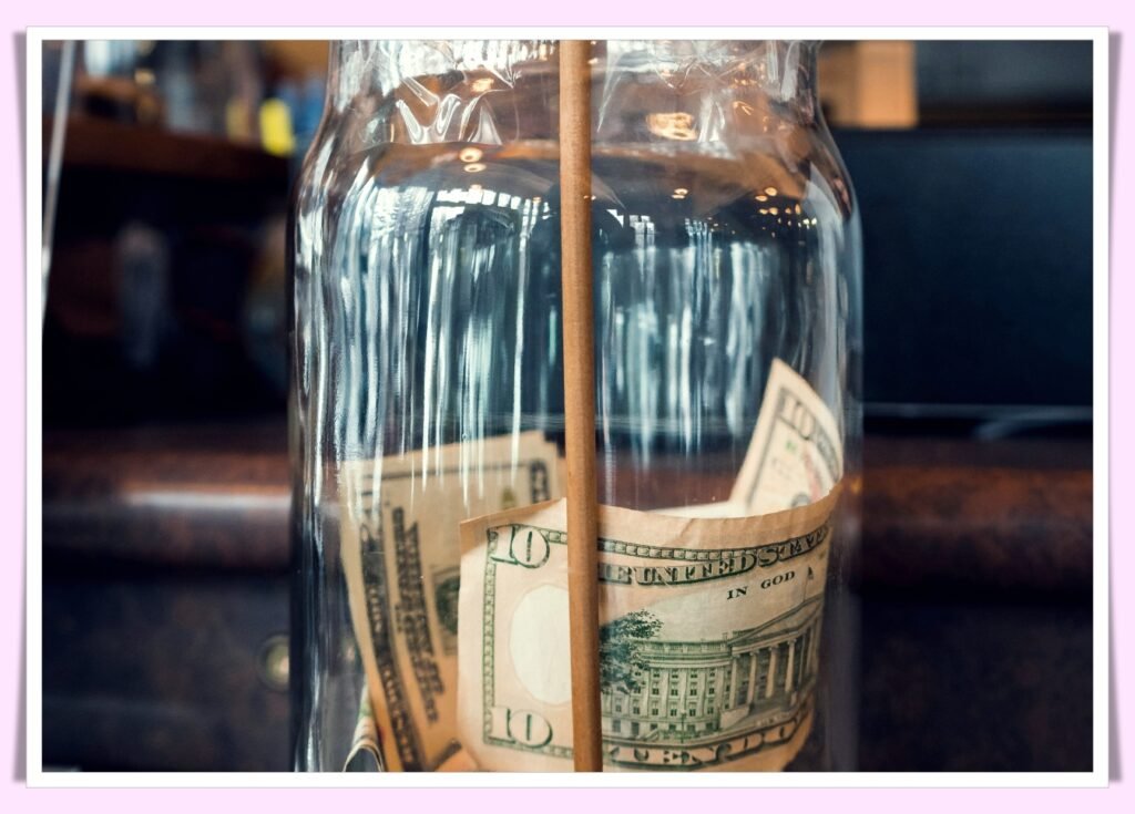 coins in jar labeled vacation savings fund